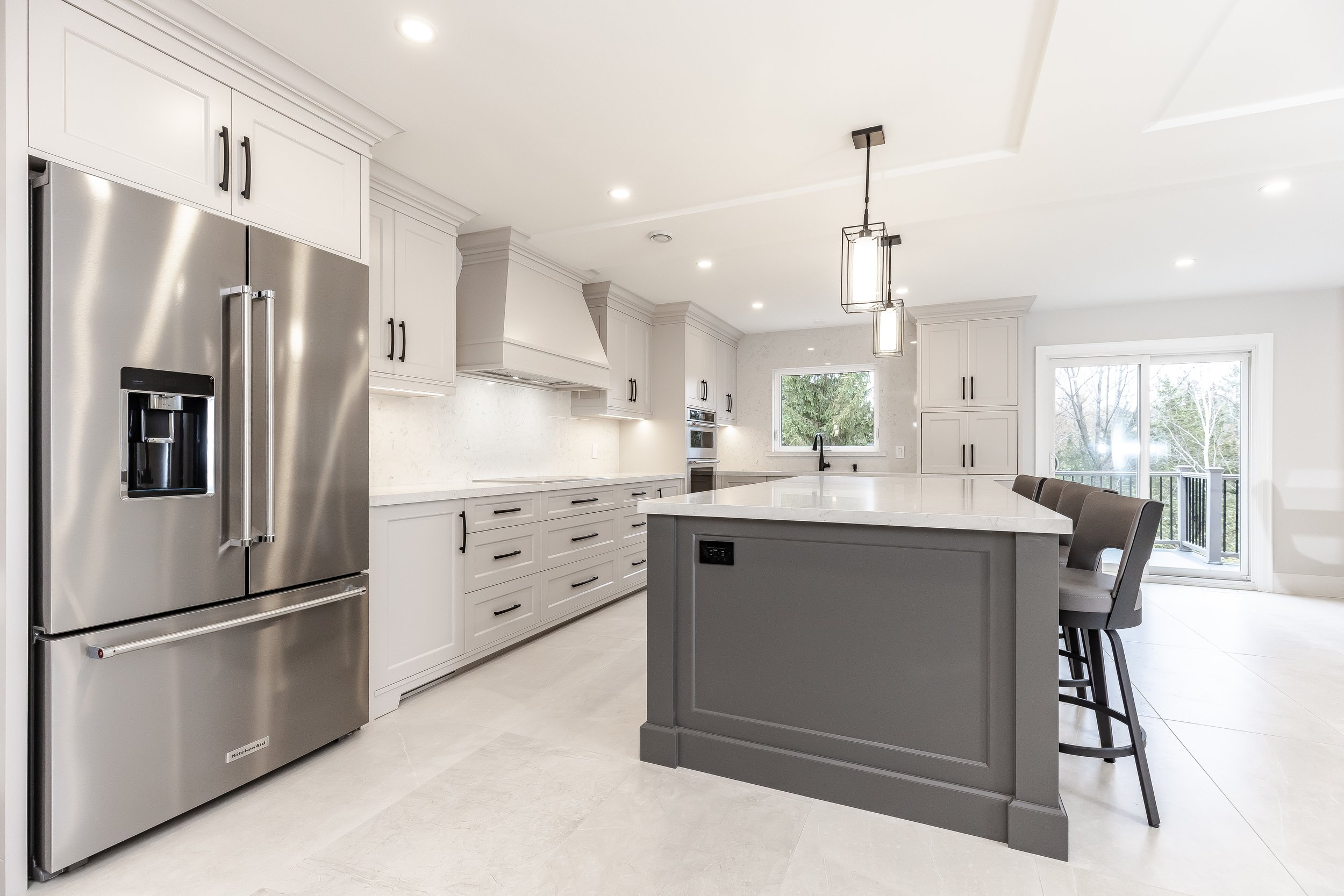 Custom transitional kitchen with island and painted cabinetry by Metrico